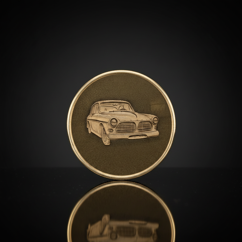 Custom embossed brass coin with classic car engraving in black display box with LED spotlight